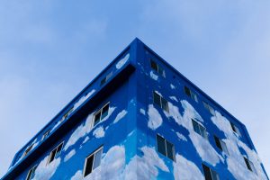 Half-finished blue building shot from a low angle